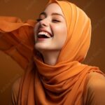 a happy muslim woman wearing a vibrant orange hijab ai stockpack adobe stock| بروفايل بنات انستقرام محجبات وبدون حجاب فخمة كيوت مختارة [صور + خلفيات]