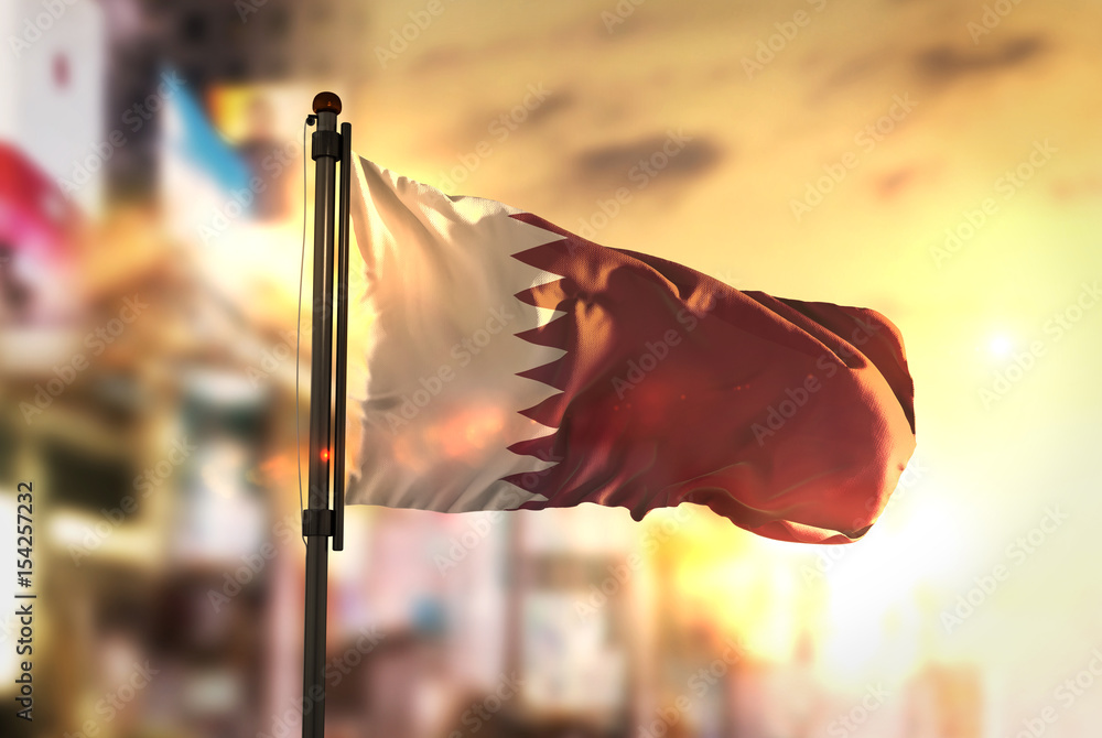qatar flag against city blurred background at sunrise backlight stockpack adobe stock| وظائف شركة بورتلاند Portland لجميع الجنسيات في قطر