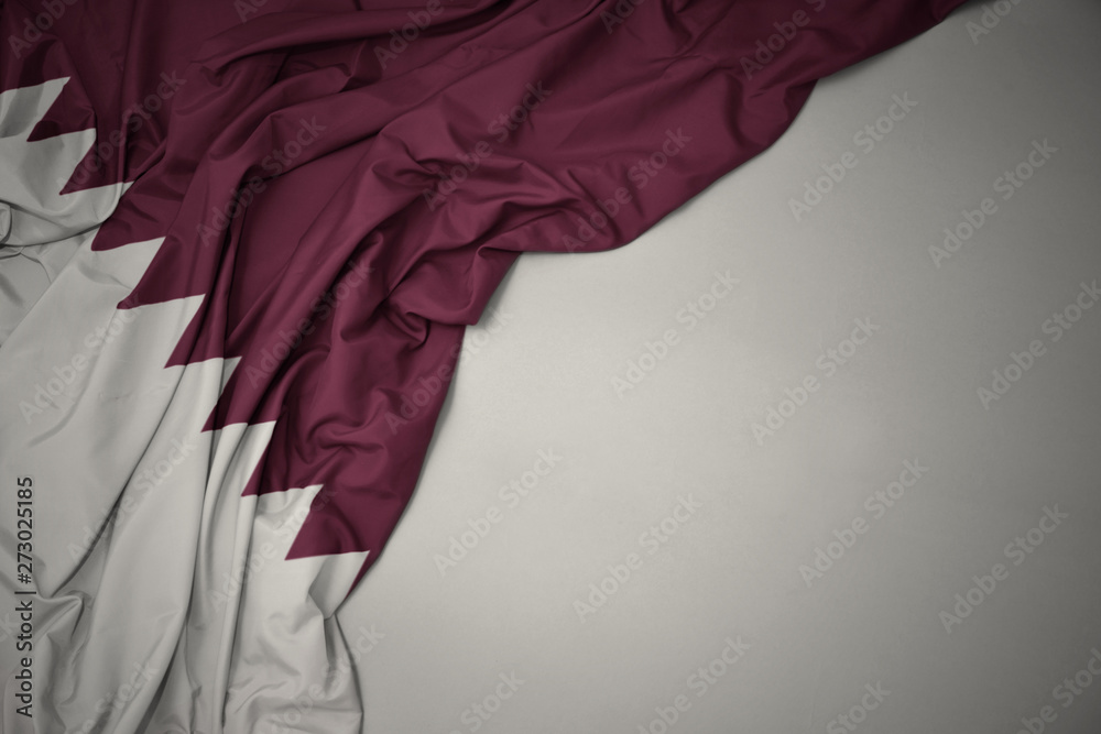 waving national flag of qatar on a gray background stockpack adobe stock| وظائف شركة صالح الحمد المانع فرص عمل برواتب مجزية فِي تخصص خدمة العملاء